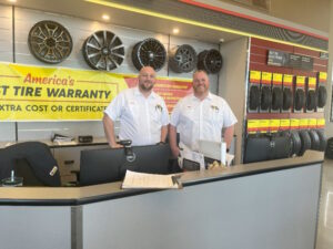 Two men standing at the counter of Les Schwab Tire Center