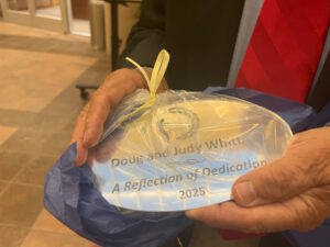 Mayor's Inspiration Award plaque inscribed with their names and "A reflection of dedication"