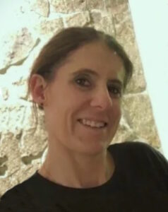 Head and shoulders photo of Liza Patty. She is wearing a black sweater and she is smiling.